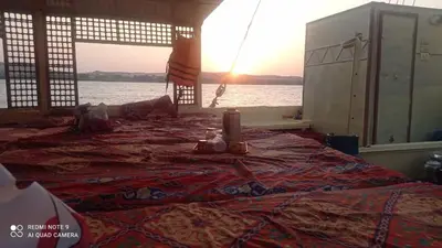 a large bed with a candle on top of it at felouque avec toilettes in Aswan