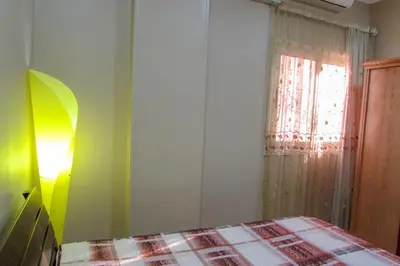 a bedroom with a bed and a window at Apartments Desert rose near the sea RedSeaLine in Hurghada