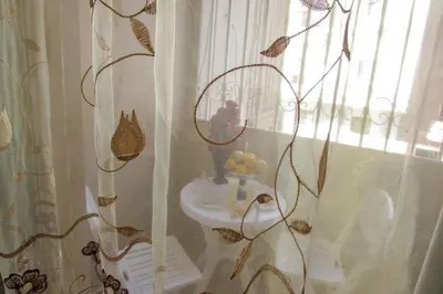 a bathroom with a white sink and a window at Apartments Desert rose near the sea RedSeaLine in Hurghada