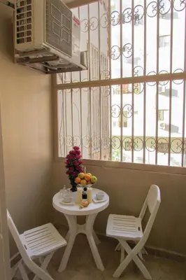 a table and two chairs and a table and a window at Apartments Desert rose near the sea RedSeaLine in Hurghada