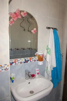 a bathroom with a sink and a mirror at Apartments Desert rose near the sea RedSeaLine in Hurghada