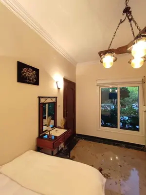a bedroom with a bed and a desk and a window at Villa Rayan in Hurghada