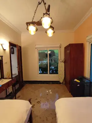 an empty room with two beds and a window at Villa Rayan in Hurghada