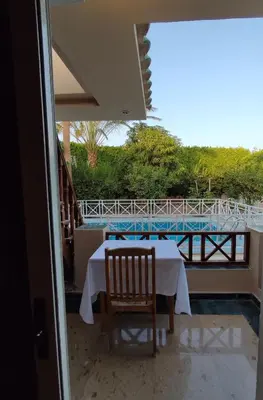 a table and chairs on the balcony of a house at Villa Rayan in Hurghada