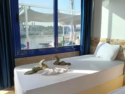 a bedroom with a bed with a large window at El-amin Guest House in Aswan