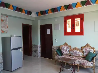 a living room with a couch and a refrigerator at El-amin Guest House in Aswan