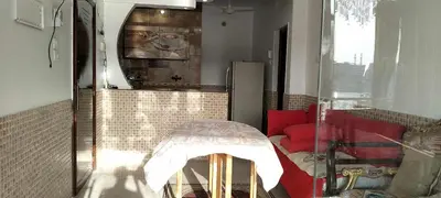 a living room with a red couch and a mirror at El-amin Guest House in Aswan