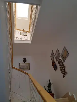 a staircase with a window and pictures on the wall at Luxor VIP Apartments in Luxor