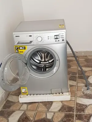 a washing machine sitting on the floor next to a wall at Luxor VIP Apartments in Luxor