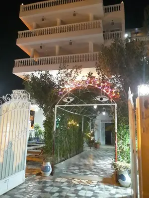 an entrance to a building with christmas lights at Luxor VIP Apartments in Luxor