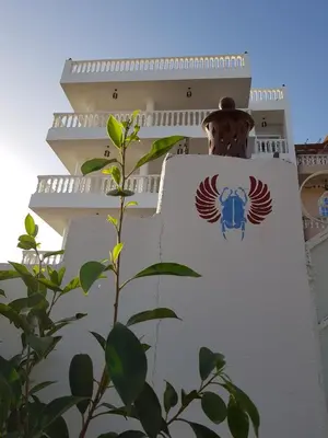 a building with an emblem on the side of it at Luxor VIP Apartments in Luxor
