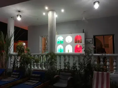 a room with chairs and a wall with lights at Luxor VIP Apartments in Luxor