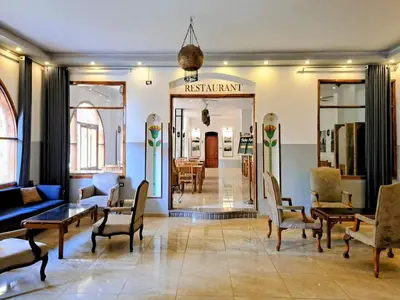a living room with a couch and chairs and a mirror at Thebes Hotel in Luxor