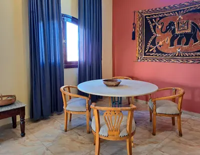 a dining room with a table and two chairs at Thebes Hotel in Luxor