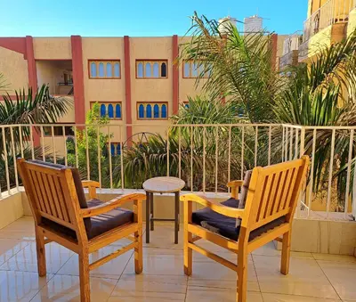 two chairs and a table on a balcony at Thebes Hotel in Luxor