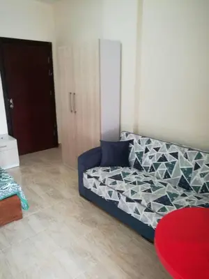 a living room with a blue couch in a room at Tiba Resort AA in Hurghada
