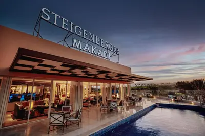 a hotel with a swimming pool in front of a building at Steigenberger Makadi - Adults Friendly 16 Years Plus in Hurghada