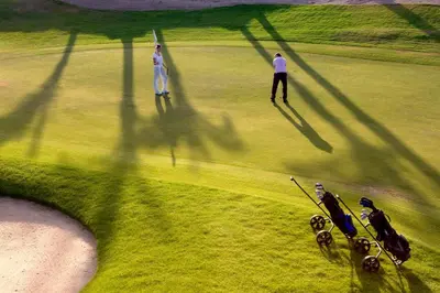 a couple of people standing on a golf course at Steigenberger Makadi - Adults Friendly 16 Years Plus in Hurghada