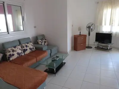 a living room with a couch and a tv at Spring Hotel Luxor in Luxor