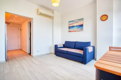 a living room with a blue couch in a room at Andalusia Blue Beach Hurghada in Hurghada