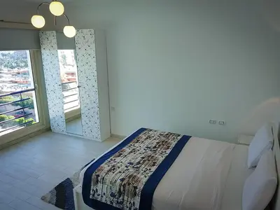 a bedroom with a bed and a large window at Andalusia Blue Beach Hurghada in Hurghada