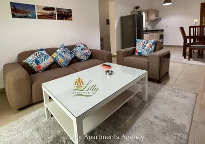 a living room with a couch and a table at Lilly Apartments in Hurghada
