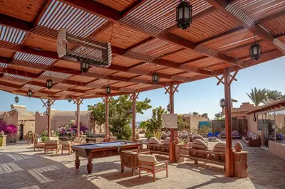 a wooden patio with a ping pong table and benches at Silver Beach Boutique Hotel in Quseir