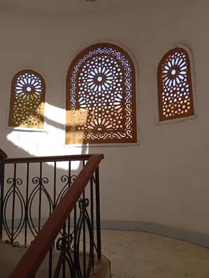 a room with two windows and a stair railing at Adam and Eve House in Luxor