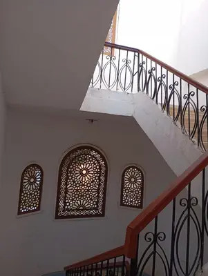 a staircase with two windows and a stair railing at Adam and Eve House in Luxor