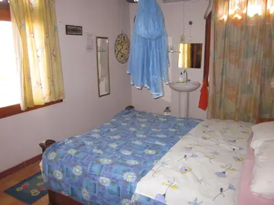 a small bedroom with a bed and a sink at Bet El Kerem Guesthouse in Aswan