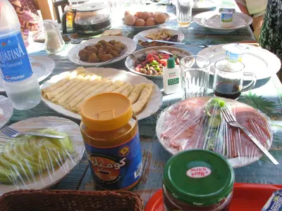 a table topped with plates of food and eggs at Bet El Kerem Guesthouse in Aswan