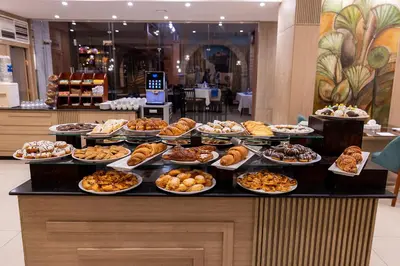 a buffet with many plates of food on a counter at Basma Hotel Aswan in Aswan