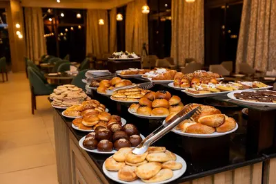 a buffet line with different types of pastries and desserts at Basma Hotel Aswan in Aswan