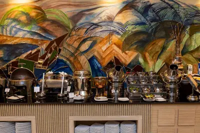 a counter with pots and pans and a mural at Basma Hotel Aswan in Aswan