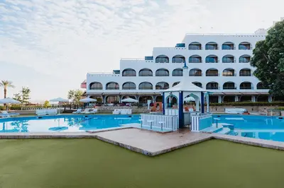 a large white hotel with a pool and a gazebo at Basma Hotel Aswan in Aswan