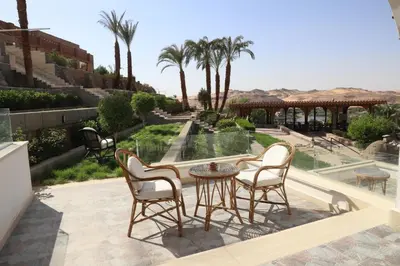 a patio with a table and chairs and a park at Basma Hotel Aswan in Aswan