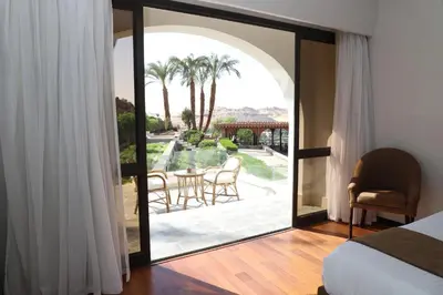 a bedroom with a large glass door leading to a patio at Basma Hotel Aswan in Aswan