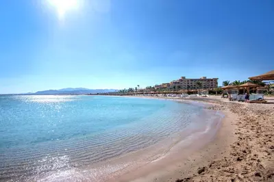 a view of the beach with buildings in the background at Shams Prestige Abu Soma (Adults Only) in Hurghada