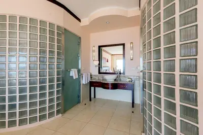a bathroom with glass block walls and a sink at Shams Prestige Abu Soma (Adults Only) in Hurghada