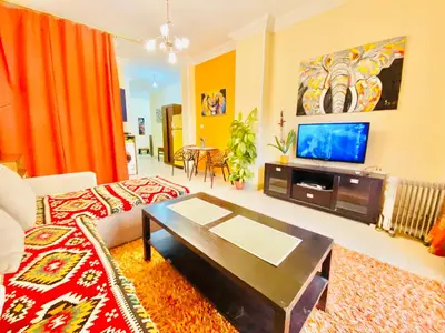 a living room with a couch and a tv at Safari Home with Wi Fi Hurghada center in Hurghada