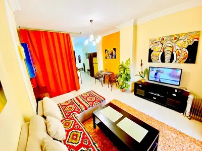 a living room with a couch and a tv at Safari Home with Wi Fi Hurghada center in Hurghada