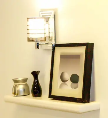 a picture on a shelf with a vase and a mirror at Lima Modern Sheraton with Wi Fi in Hurghada