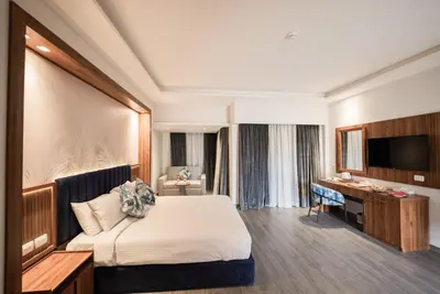 a hotel room with a bed and a desk at Golden Beach Resort in Hurghada