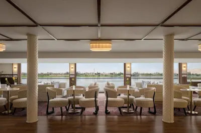 a large room with tables and chairs and a large window at Tamr Nile Cruise - 04 Nights Every Monday from Luxor - 03 Nights Every Friday from Aswan in Luxor