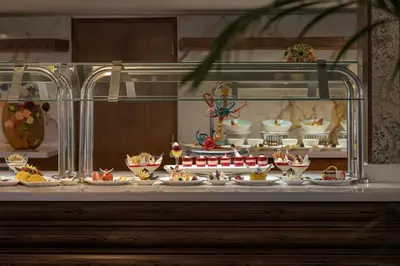 a display case filled with plates of food on a table at Tamr Nile Cruise - 04 Nights Every Monday from Luxor - 03 Nights Every Friday from Aswan in Luxor