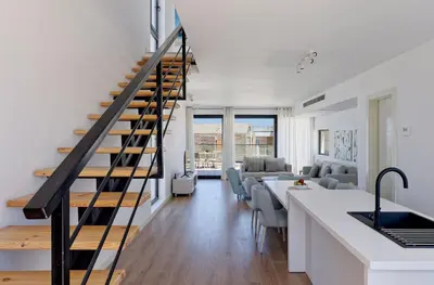 a kitchen and living room with a staircase in a house at VESTA - Soma Bay Residence in Hurghada