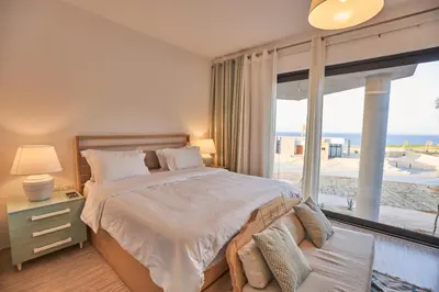 a bedroom with a bed with a view of the beach at VESTA - Soma Bay Residence in Hurghada