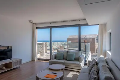 a living room with a couch and a large window at VESTA - Soma Bay Residence in Hurghada