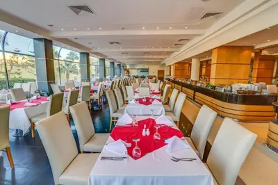 a dining room with tables and chairs with red napkins at Palm Beach Resort Families and Couples only in Hurghada