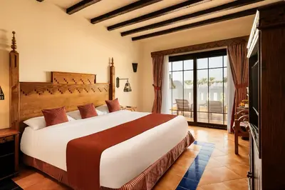 a bedroom with a large bed and a balcony at Grand Makadi - Couples and Families Only in Hurghada